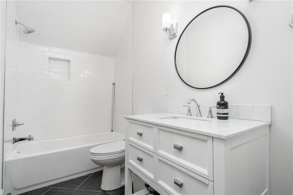 216 Haralson Lane Atlanta, GA 30307 - Photo 23 of 33 a bathroom with a sink a toilet and a mirror