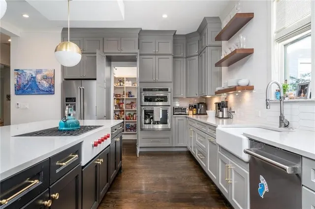 a kitchen with stainless steel appliances granite countertop a stove and cabinets