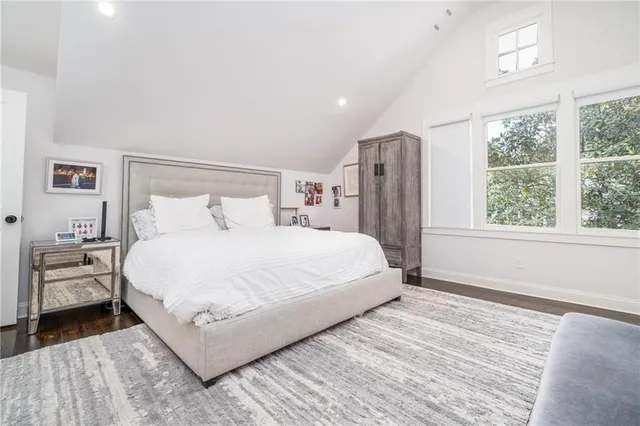 a bedroom with a large bed and a window