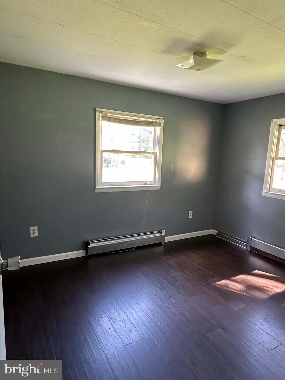 805 Baltimore Road Shippensburg, PA 17257 - Photo 12 of 23 an empty room with wooden floor and windows
