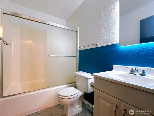 a bathroom with a sink toilet and a mirror