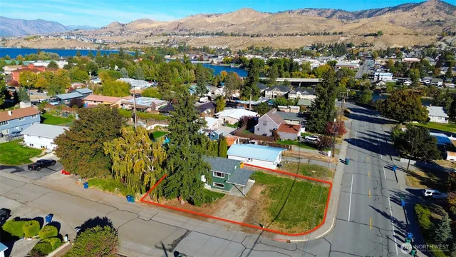 an aerial view of residential houses with outdoor space and parking