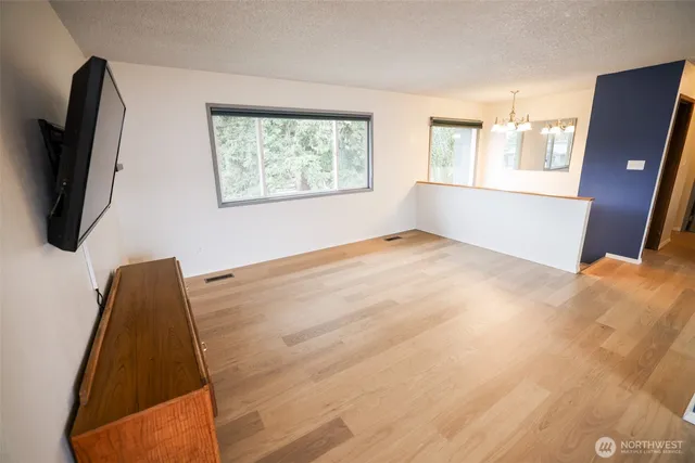 a view of a bedroom with window and a flat screen tv