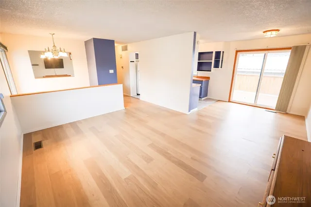 a view of a kitchen with a sink and a refrigerator