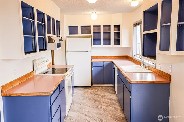 a kitchen with stainless steel appliances granite countertop a sink stove and cabinets