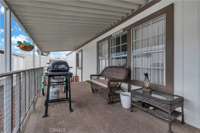 a living room with furniture a rug and a table