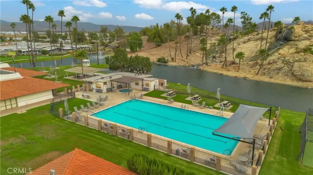 an aerial view of a house with outdoor space swimming pool and lake view