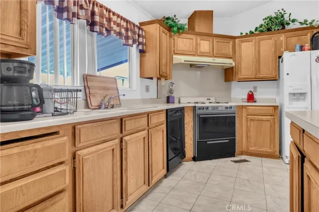 a kitchen with stainless steel appliances granite countertop a sink and cabinets