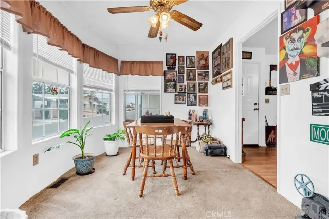 a dining room with furniture and a floor to ceiling window