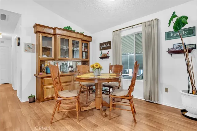 a dining room with furniture and wooden floor