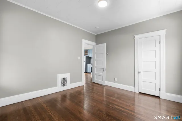 a view of a room with wooden floor and window