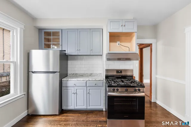 a kitchen with a refrigerator stove and cabinets