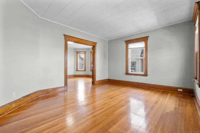 a view of a room with wooden floor and window