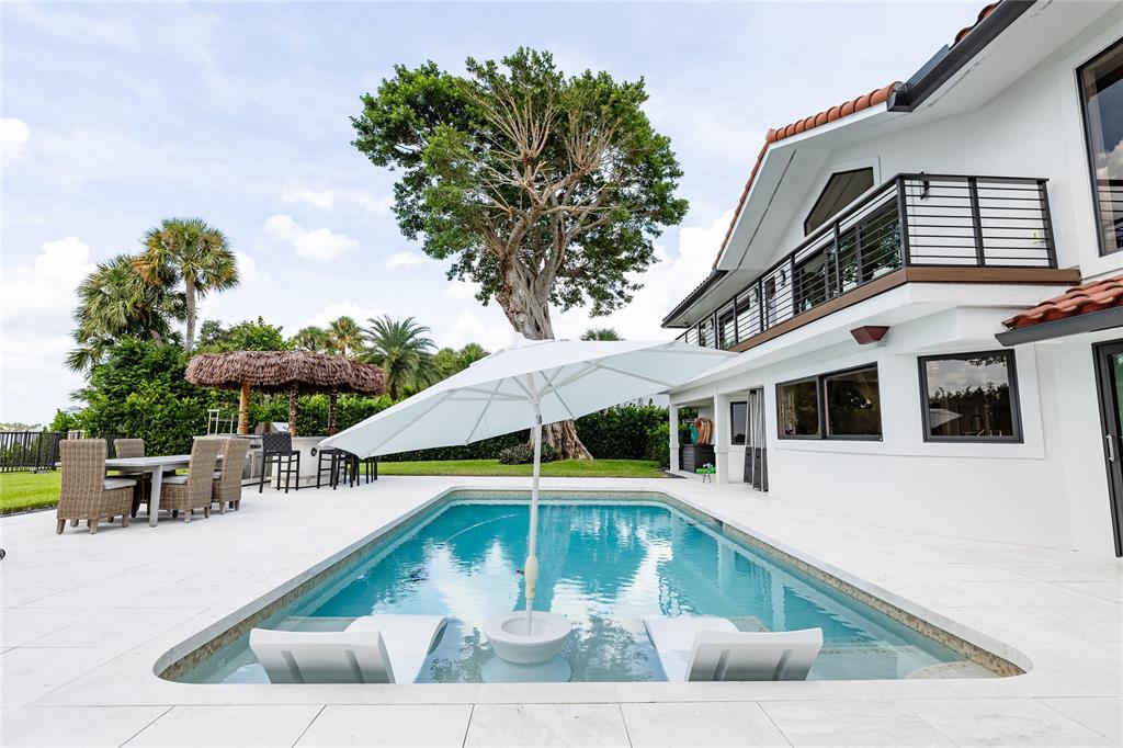 9 North River Road Stuart, FL 34996 - Photo 19 of 75 a view of a swimming pool with an outdoor seating