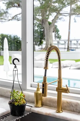 a living room with furniture a wooden floor and a large window