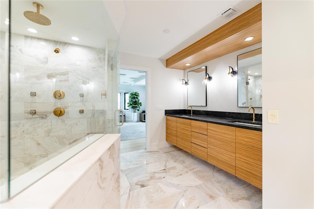9 North River Road Stuart, FL 34996 - Photo 29 of 75 a bathroom with a granite countertop sink a mirror and a bathtub