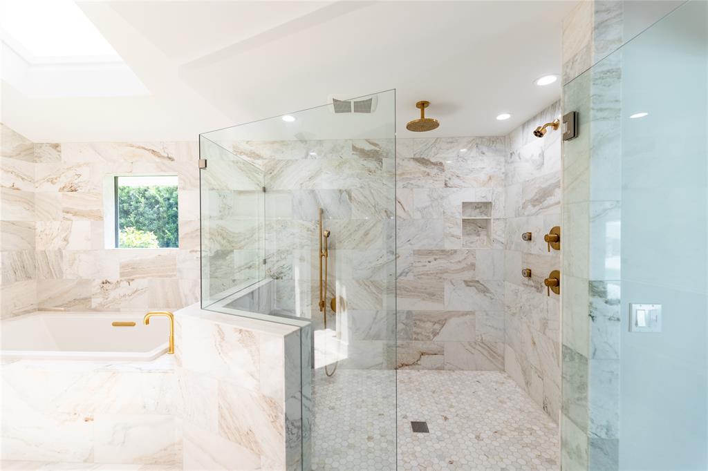 9 North River Road Stuart, FL 34996 - Photo 31 of 75 a bathroom with a bathtub and a shower