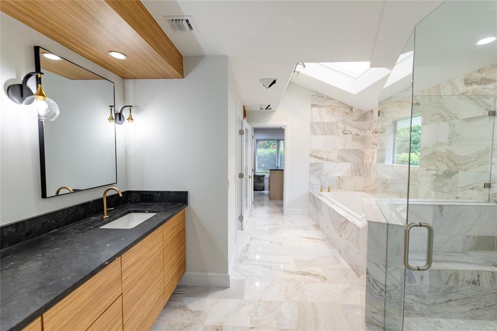 9 North River Road Stuart, FL 34996 - Photo 35 of 75 a spacious bathroom with a granite countertop sink a mirror and shower