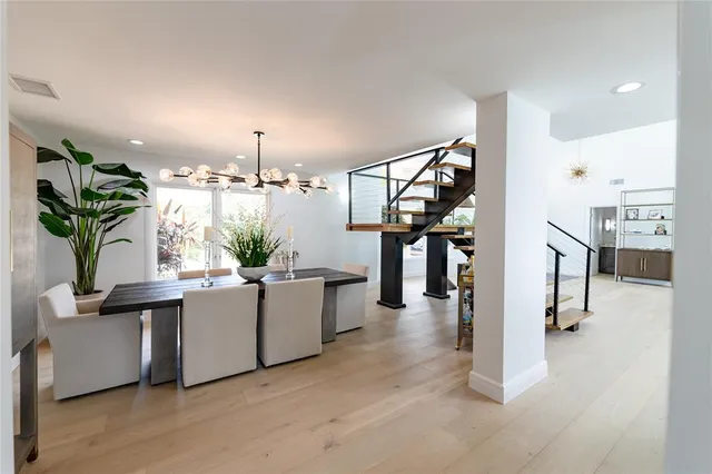 a bathroom with a granite countertop sink a mirror and a potted plant