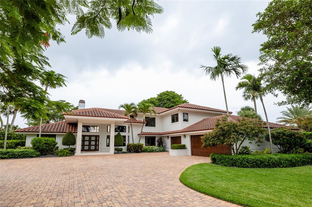 9 North River Road Stuart, FL 34996 - Photo 5 of 75 a front view of a house with a garden