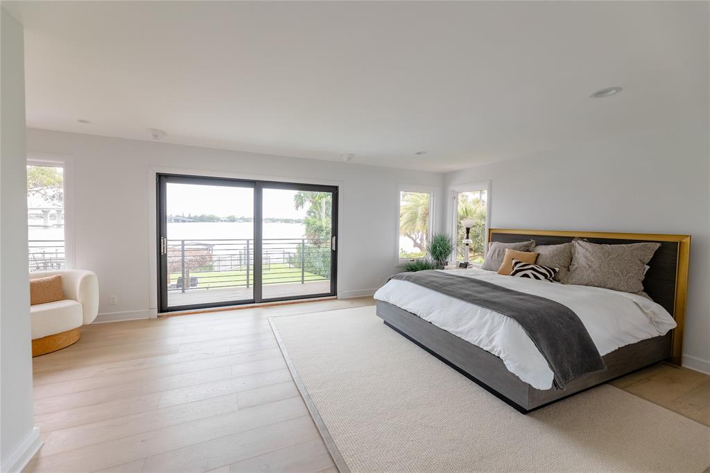 9 North River Road Stuart, FL 34996 - Photo 53 of 75 a spacious bedroom with a large bed and a large window