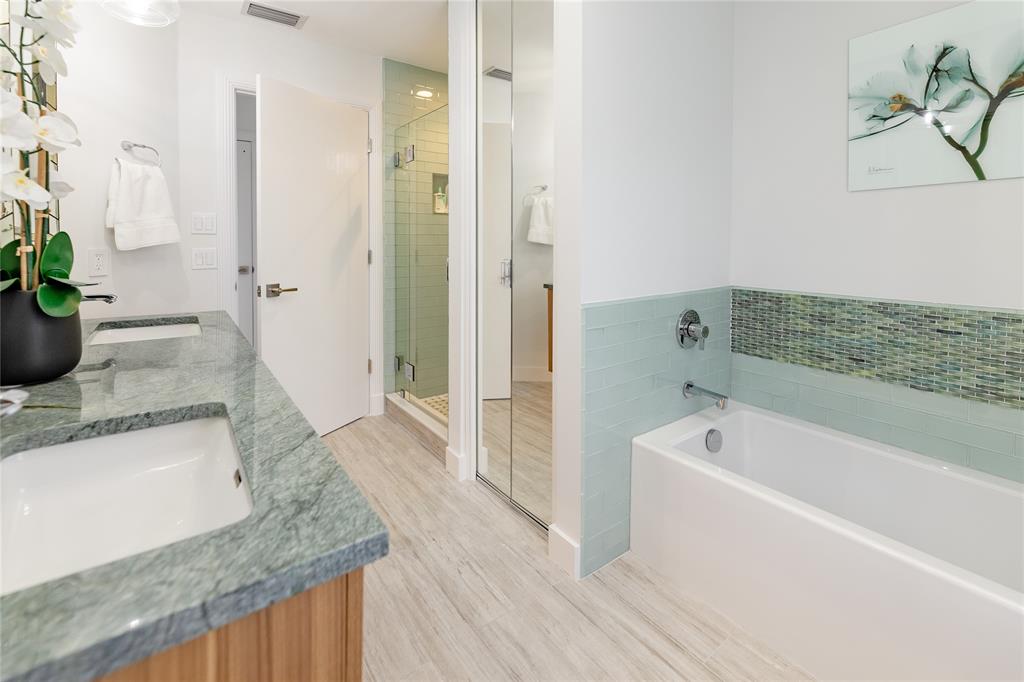 9 North River Road Stuart, FL 34996 - Photo 65 of 75 a bathroom with a granite countertop sink a bathtub and a shower