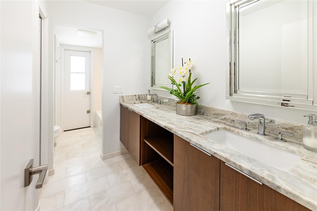 9 North River Road Stuart, FL 34996 - Photo 67 of 75 a bathroom with a granite countertop sink a mirror and a potted plant