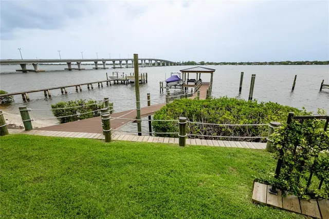 a view of a house with a yard and potted plants