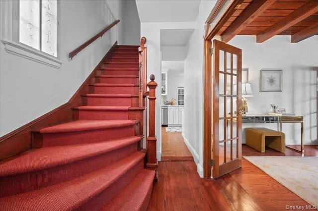 a view of entryway and hall with wooden floor