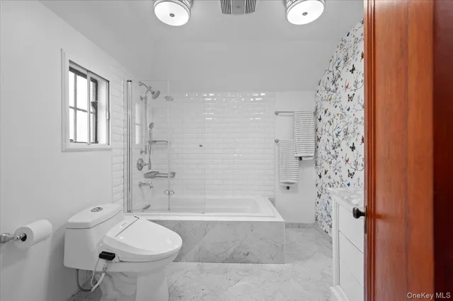 a bathroom with a bathtub sink and toilet