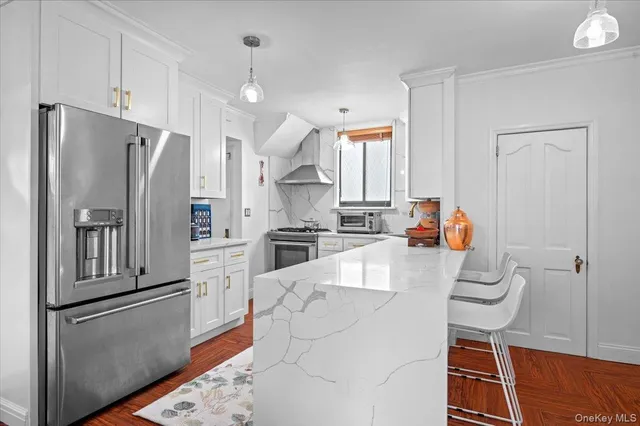 a kitchen with stainless steel appliances a refrigerator sink and stove