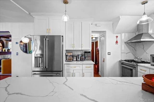 a kitchen with stainless steel appliances kitchen island a refrigerator sink and stove