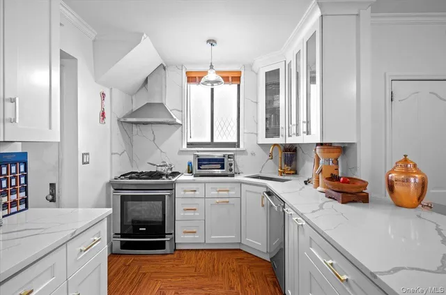 a kitchen with stainless steel appliances a sink stove and cabinets