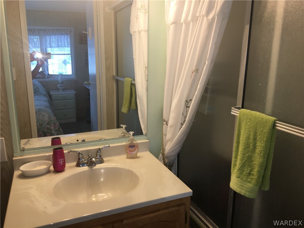 1745 Talc Road Bullhead City, AZ 86442 - Photo 11 of 31 a bathroom with a sink and a mirror