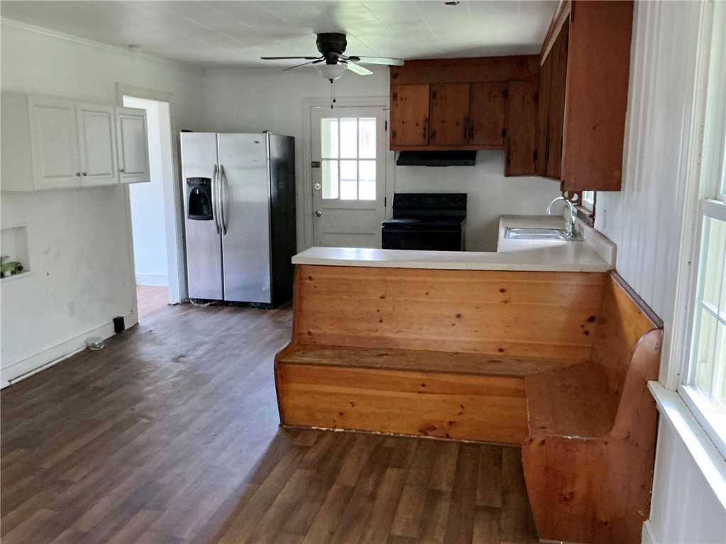 Rich wood floors lay a classic foundation in this traditional kitchen layout.