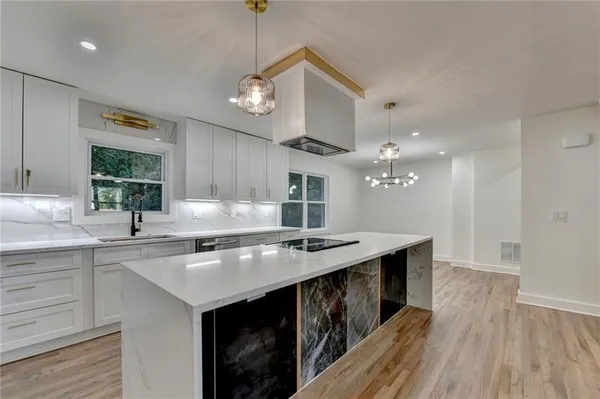 a kitchen with a sink a counter space and stainless steel appliances