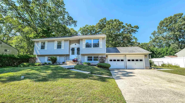 a front view of a house with a yard table and chairs