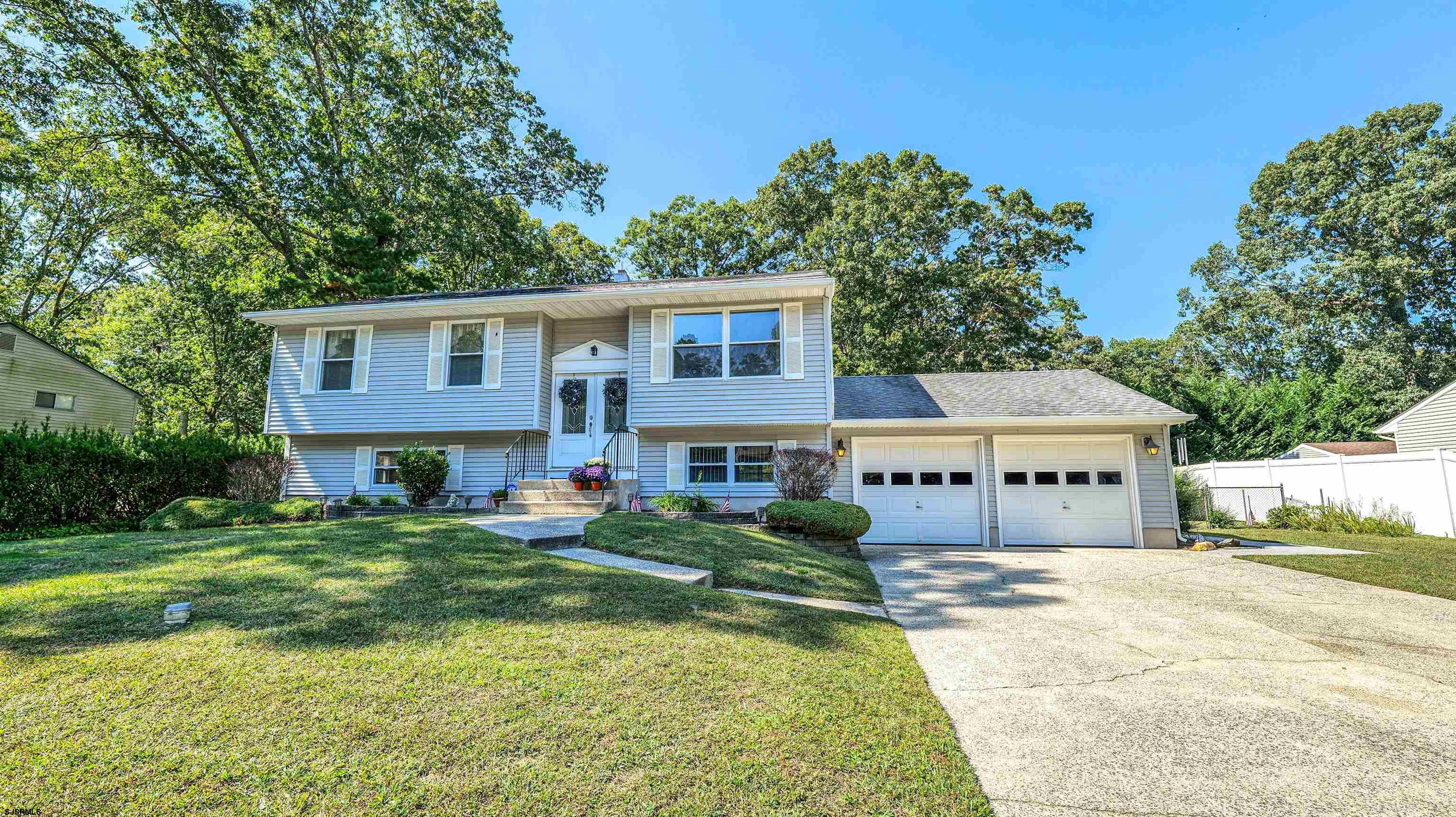 a front view of a house with a yard table and chairs