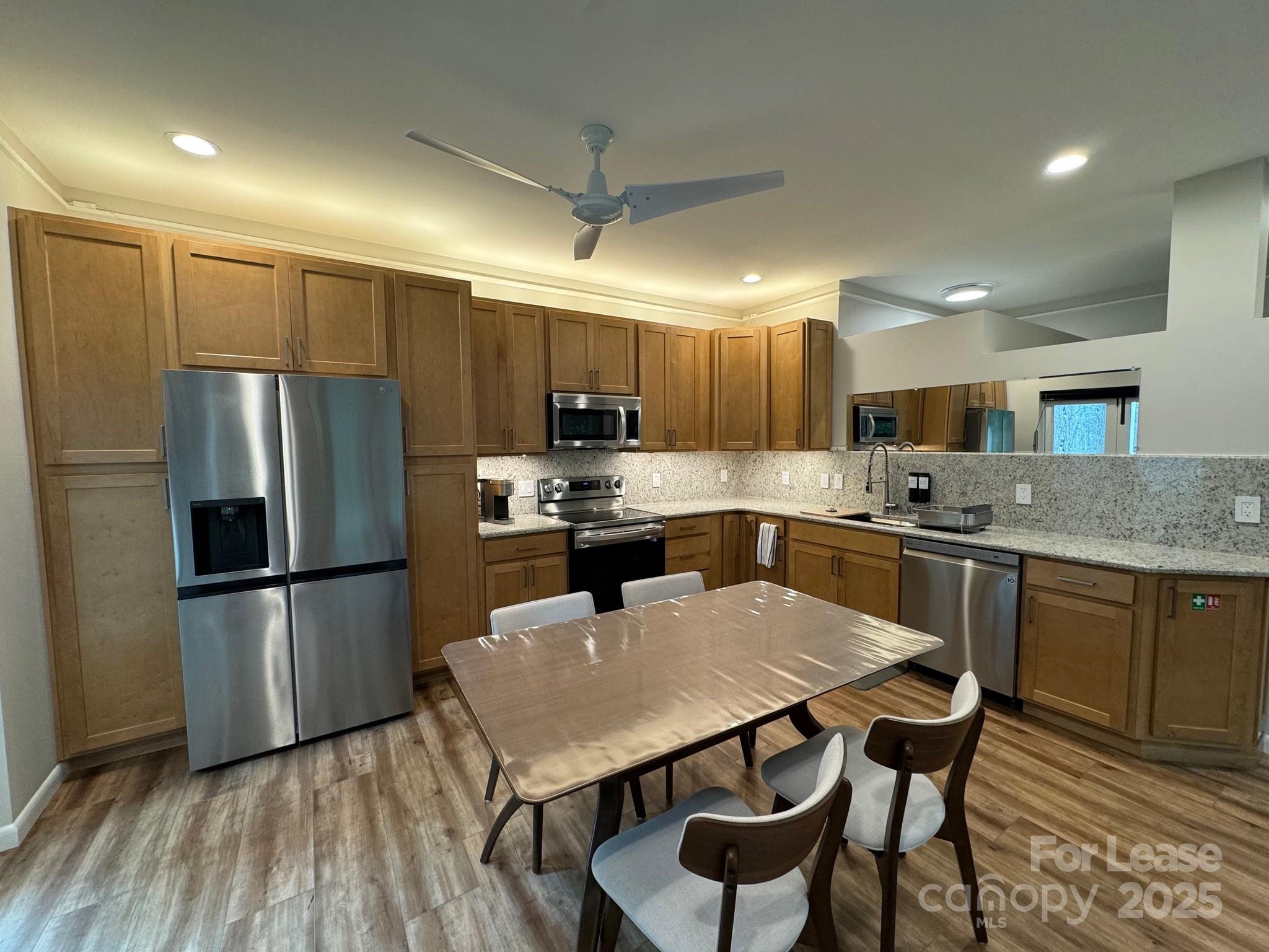 716 East Woodlawn Road Charlotte, NC 28209 - Photo 1 of 17 a kitchen with kitchen island a refrigerator a stove a sink and a oven