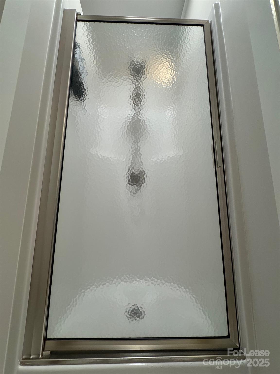 716 East Woodlawn Road Charlotte, NC 28209 - Photo 13 of 17 a bathroom with a glass shower door