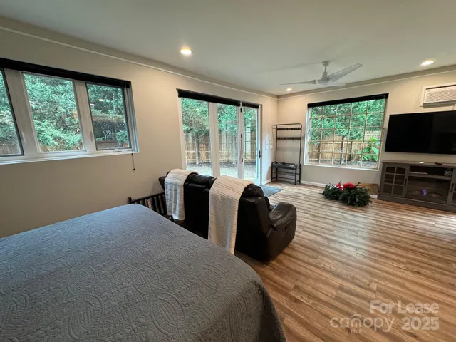 a bedroom with two beds and a flat screen tv