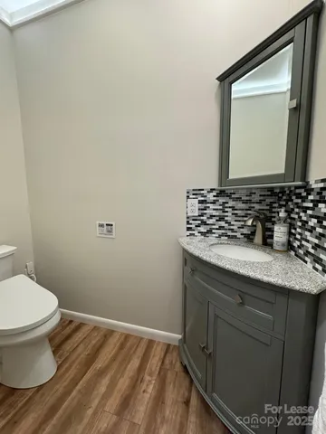 a living room with furniture a flat screen tv and floor to ceiling window