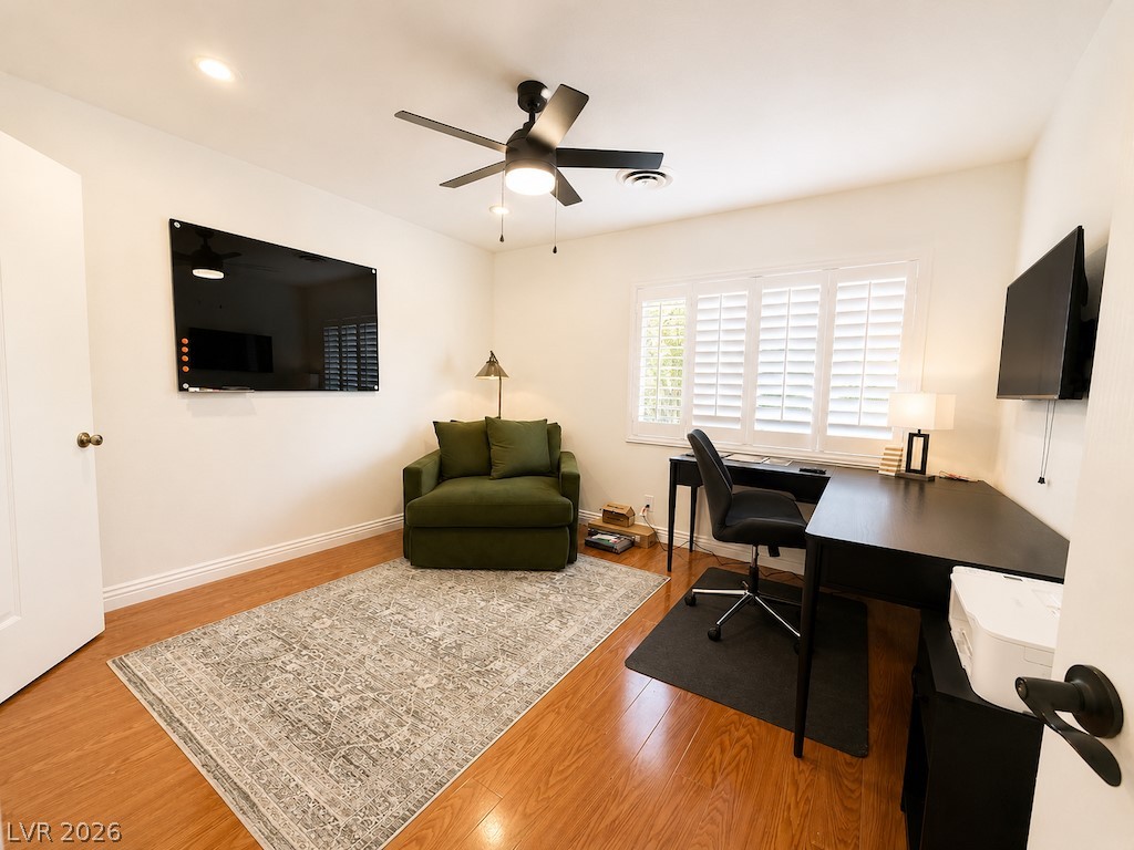3010 East Viking Road Las Vegas, NV 89121 - Photo 21 of 48 Hardwood flooring and natural light elevate this versatile home office space.