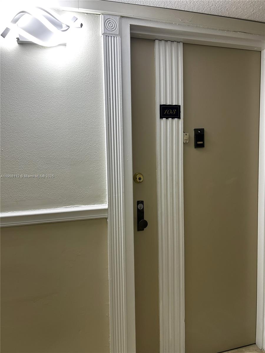 16909 North Bay Road, Unit 103 Sunny Isles Beach, FL 33160 - Photo 12 of 35 a bathroom with a glass shower door