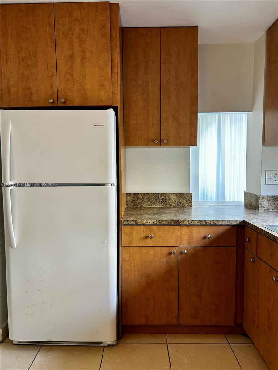 16909 North Bay Road, Unit 103 Sunny Isles Beach, FL 33160 - Photo 19 of 35 a kitchen with a refrigerator and a sink