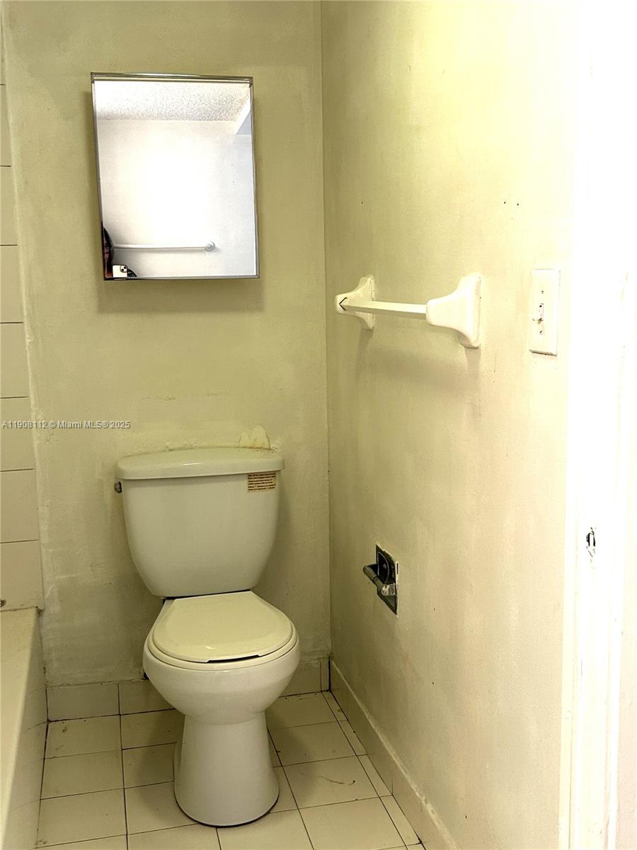 16909 North Bay Road, Unit 103 Sunny Isles Beach, FL 33160 - Photo 27 of 35 a bathroom with a toilet and a mirror