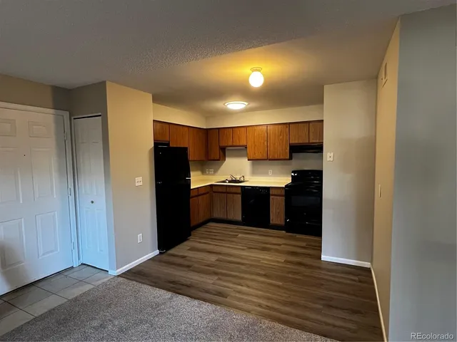 a kitchen with a refrigerator and a sink