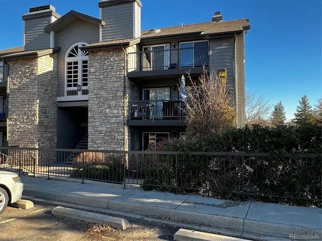 a front view of a house with plants
