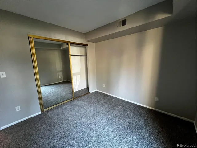 an empty room with closet area