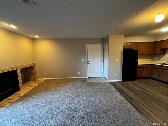 a view of an empty room with a fireplace